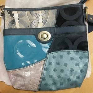 A trendy teal, navy, and grey Coach crossbody bag
